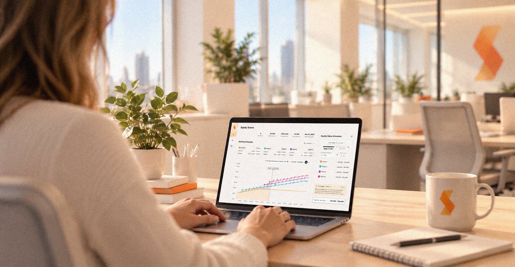Woman at a desk working on the Slice Equity Grants dashboard on a laptop
